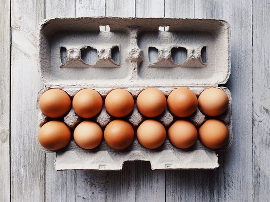 An egg carton containing a dozen of eggs