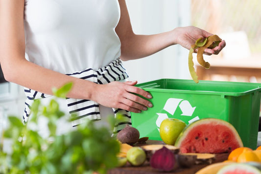A woman recycling kitchen and food scraps