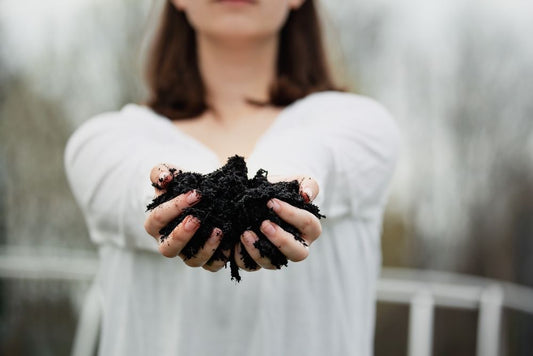 Woman holding a handful of compost
