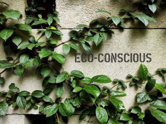 The side of a building covered in vines with the word eco-consious written on it