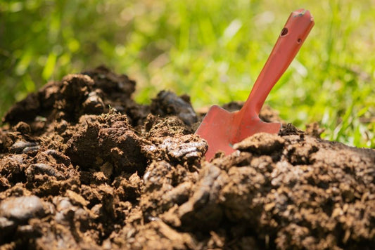 Compost soil with a shovel