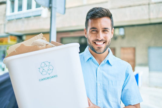 Man carrying a container with cardboard for recycling