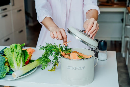 woman putting waste to compost bin